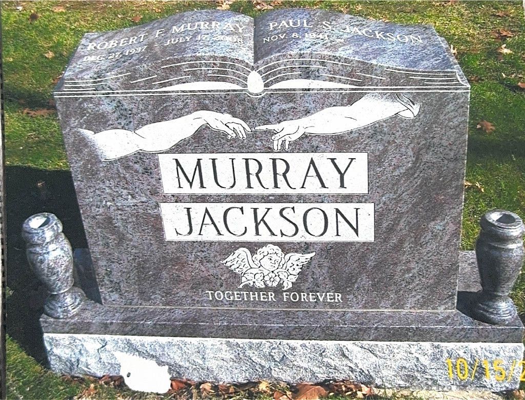 Granite gravestone reading “MURRAY JACKSON” in a grassy cemetery.