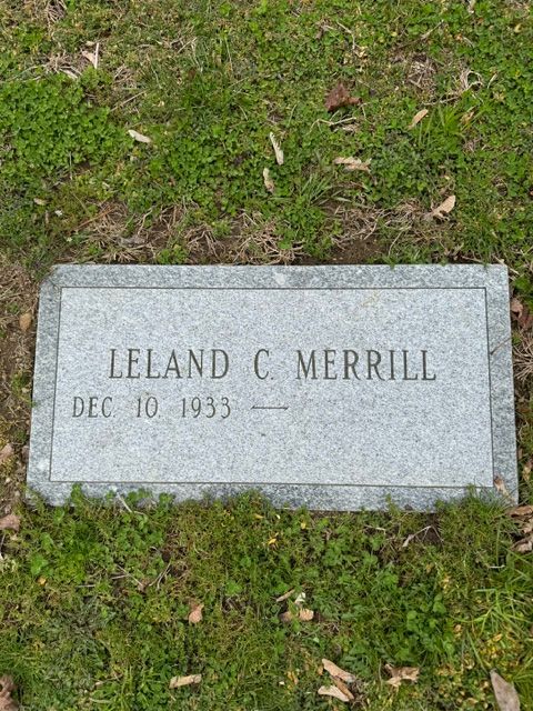 Gravestone marker reading “Leland C. Merrill” on grass
