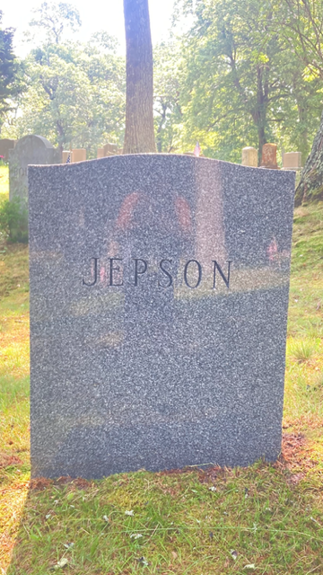 Gravestone with the name “JEPSON” in a sunny cemetery setting with trees in the background
