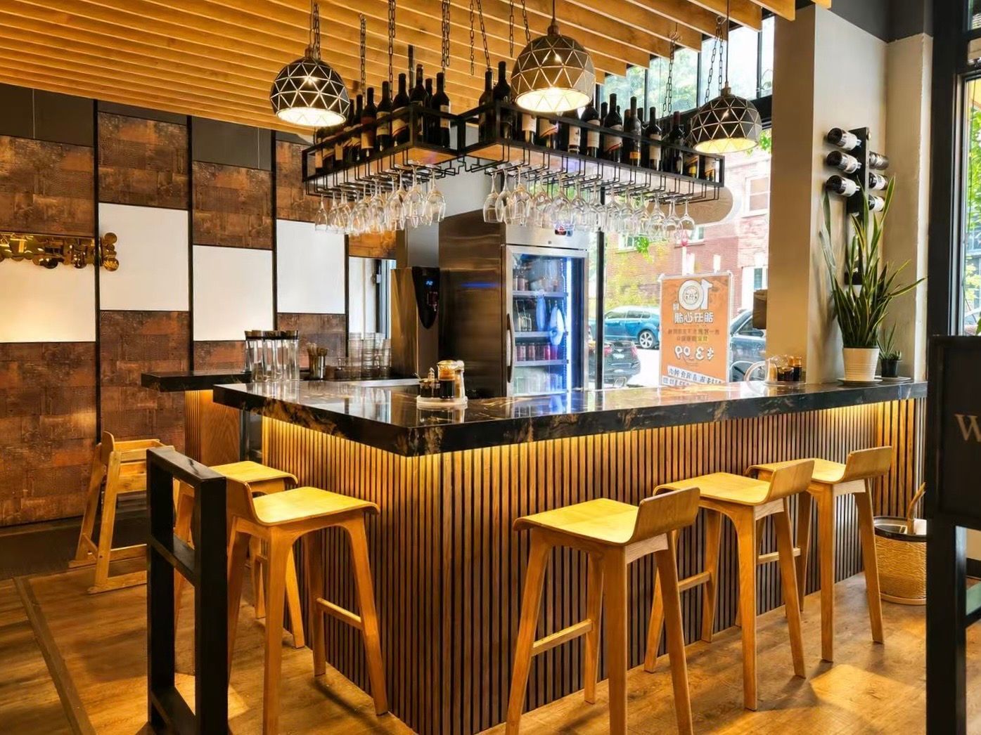 Stylish bar interior with wooden stools, hanging glassware, and warm ambient lighting