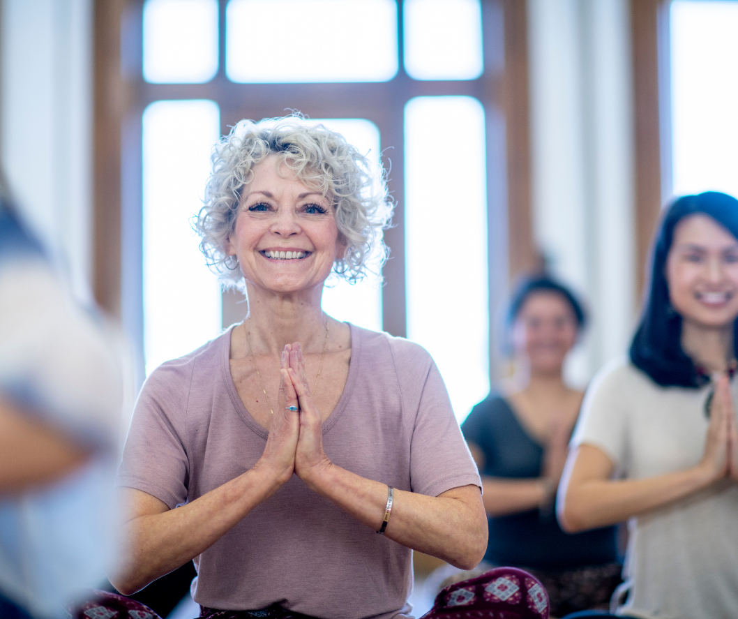 A group of women are practicing yoga together in a room.