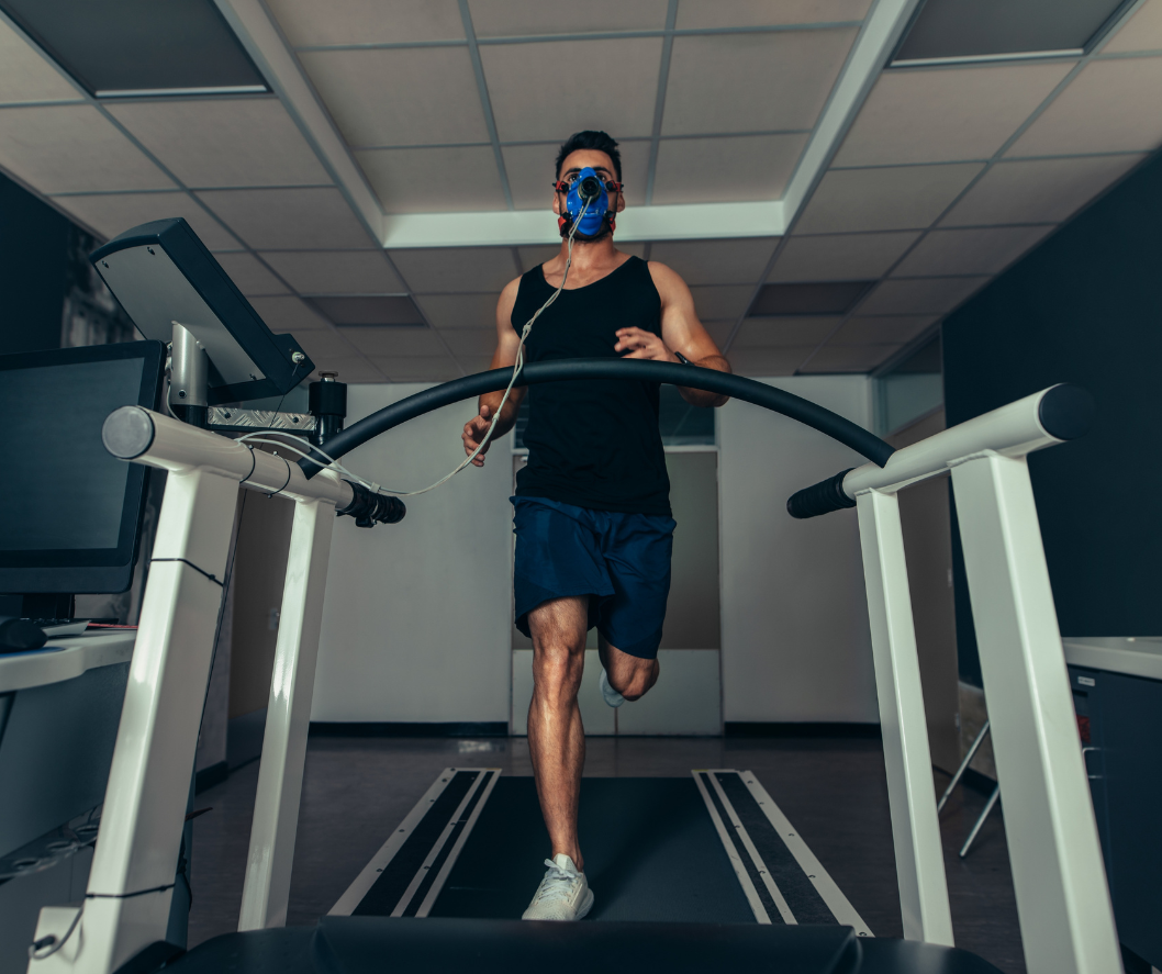 A man wearing a mask is running on a treadmill