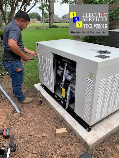 Row of white electrical utility cabinets on a concrete pad beside a grassy field under a blue sky