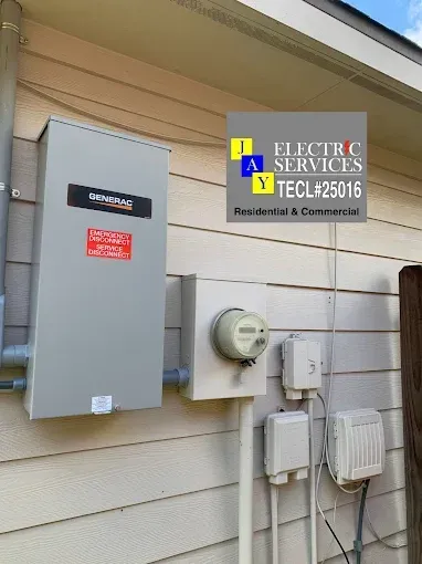 Electrical meter and service panels mounted on an exterior house wall.