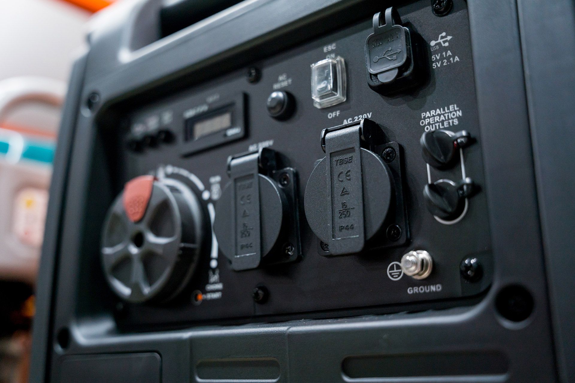 Close-up of a black vehicle dashboard panel with switches, dials, and labeled controls.