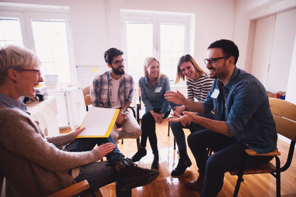 A Group of People Sit in a Circle in a Bright Room — PoDDSS in Brisbane, QLD