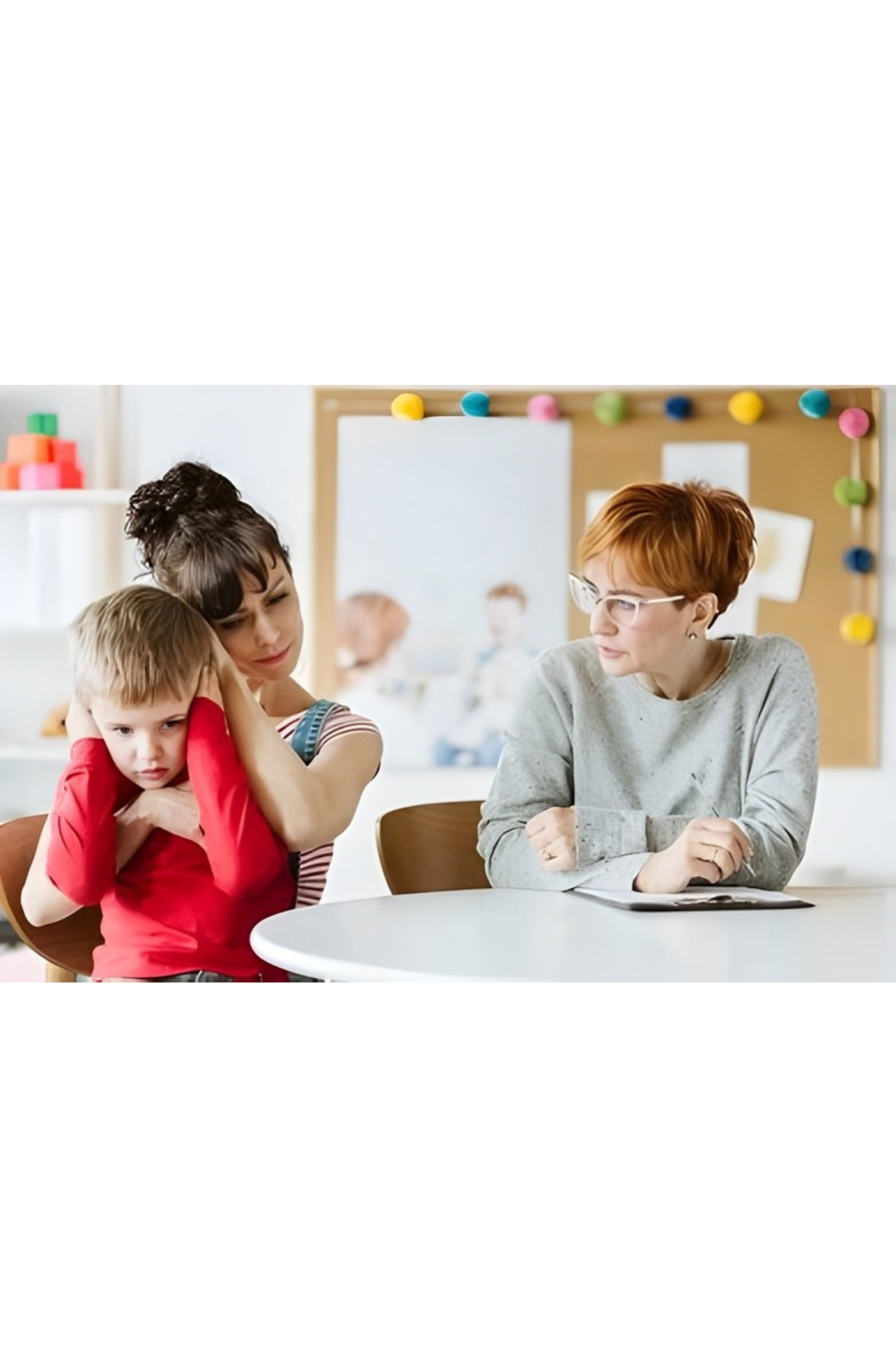 Child painting with an adult at a table, while another child sits nearby in a bright classroom — PoDDSS in Mount Isa, QLD