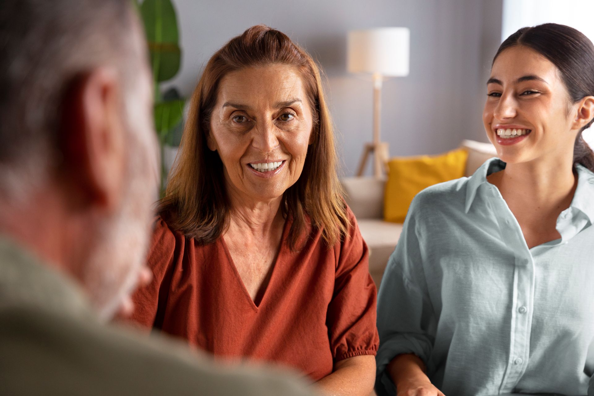 Three People Sit Together in a Bright Living Room — PoDDSS in Cairns, QLD