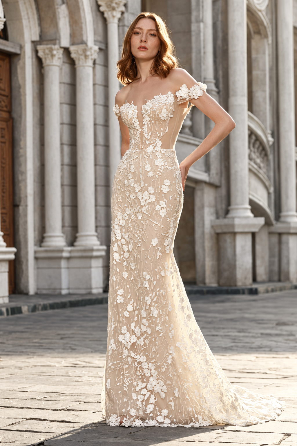 Woman in a white strapless mermaid gown posing indoors by large windows.