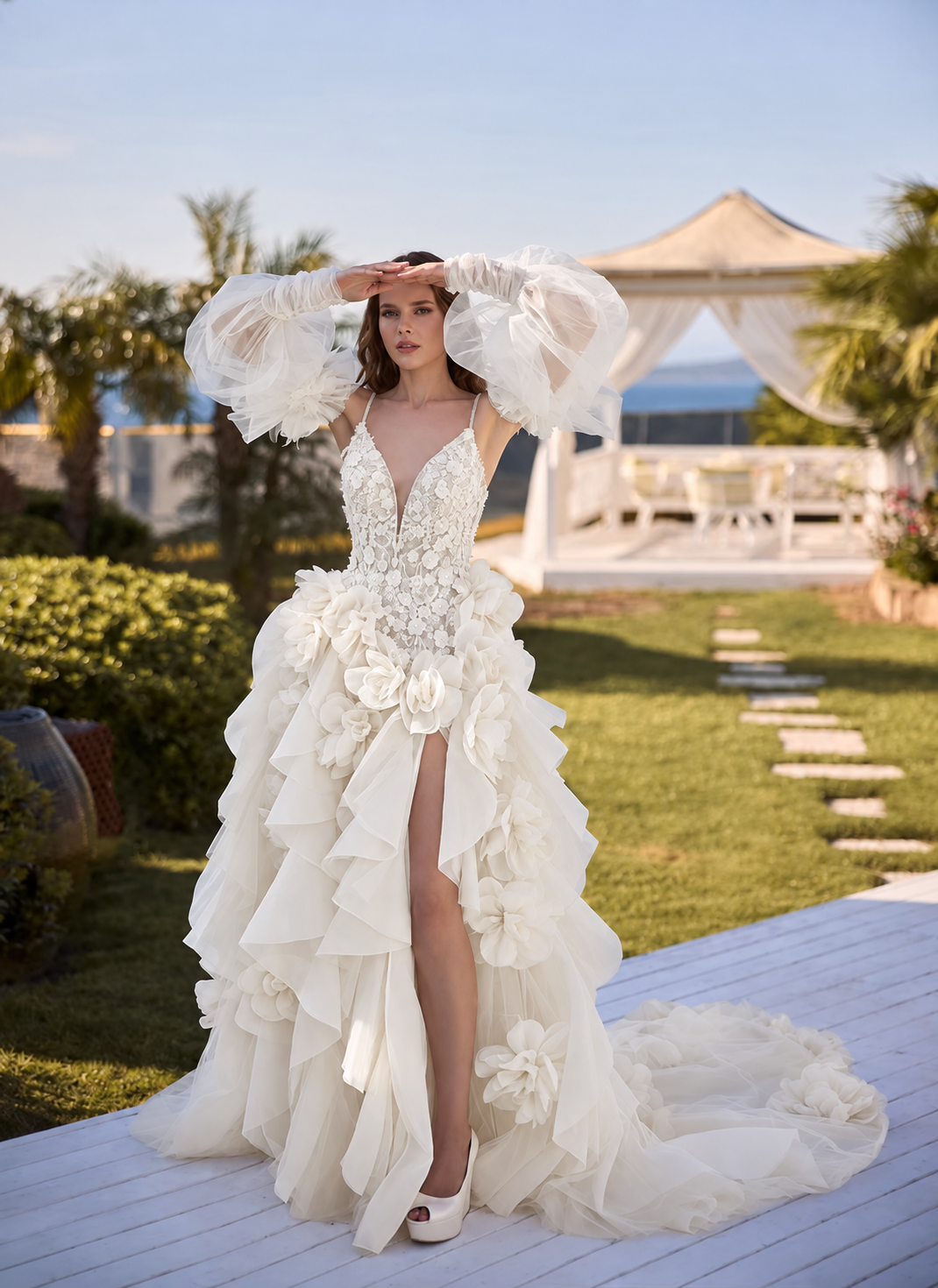 Woman in a white strapless mermaid gown posing indoors by large windows.