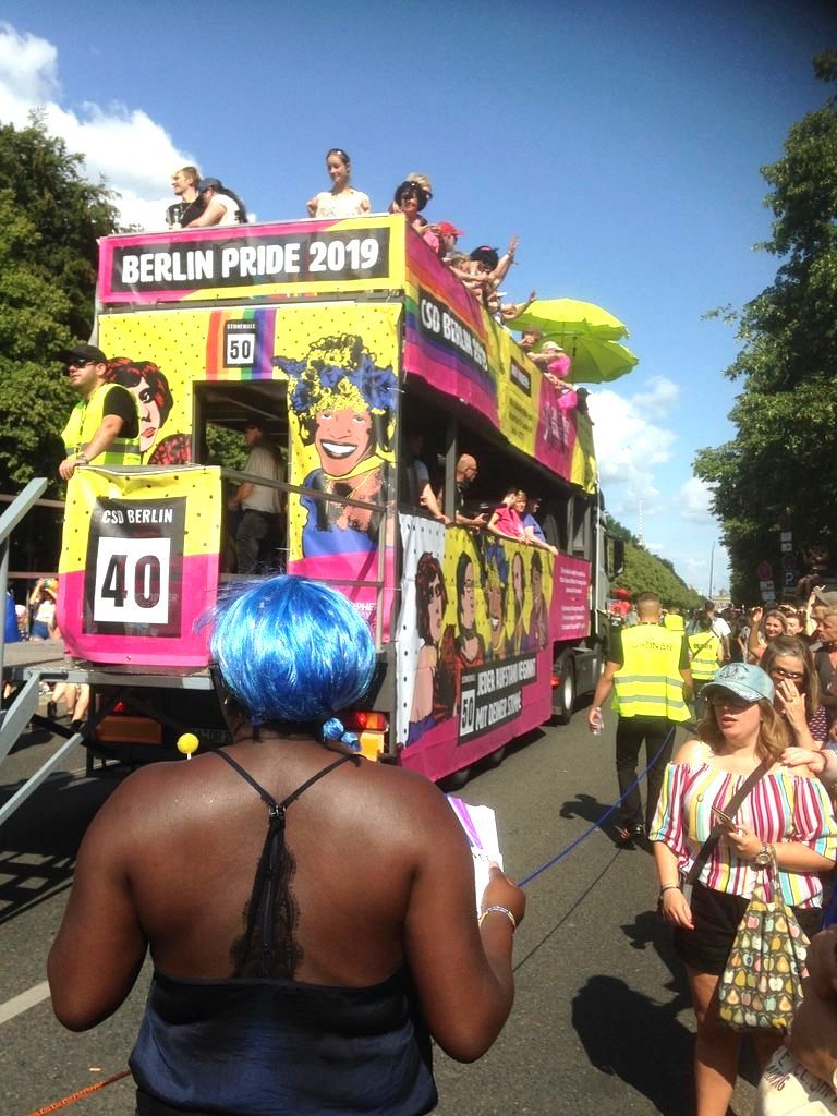 Bunter Wagen mit gemalten Bildern von queeren Menshen auf  der Pride Parade