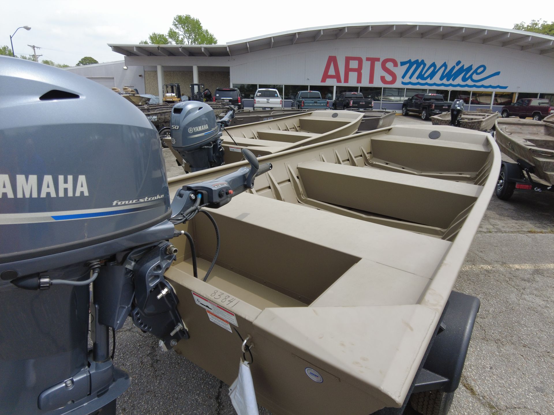 A yamaha boat is parked in front of a arts marine store