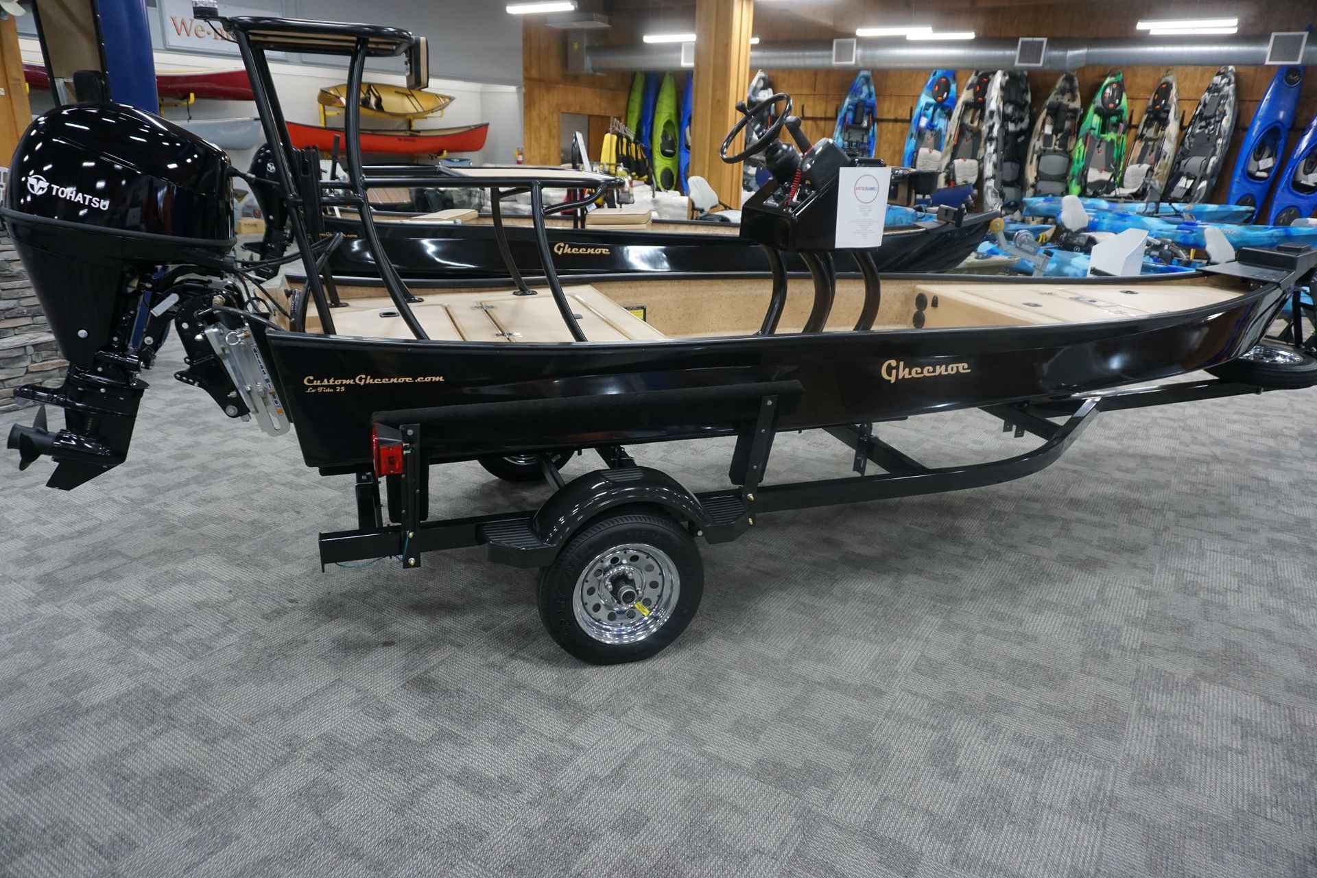 A boat is sitting on a trailer in a showroom.