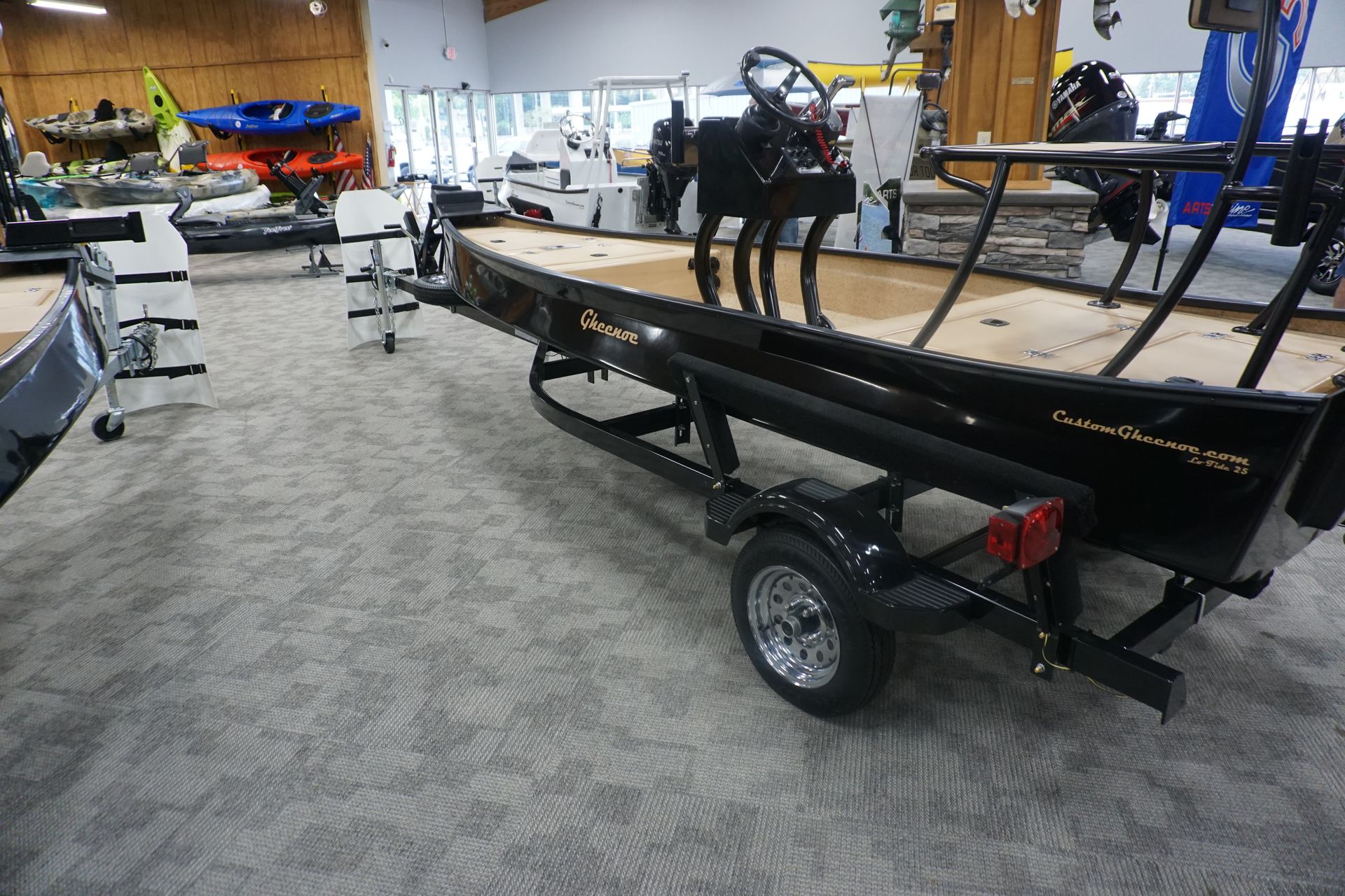 A boat is sitting on a trailer in a showroom.