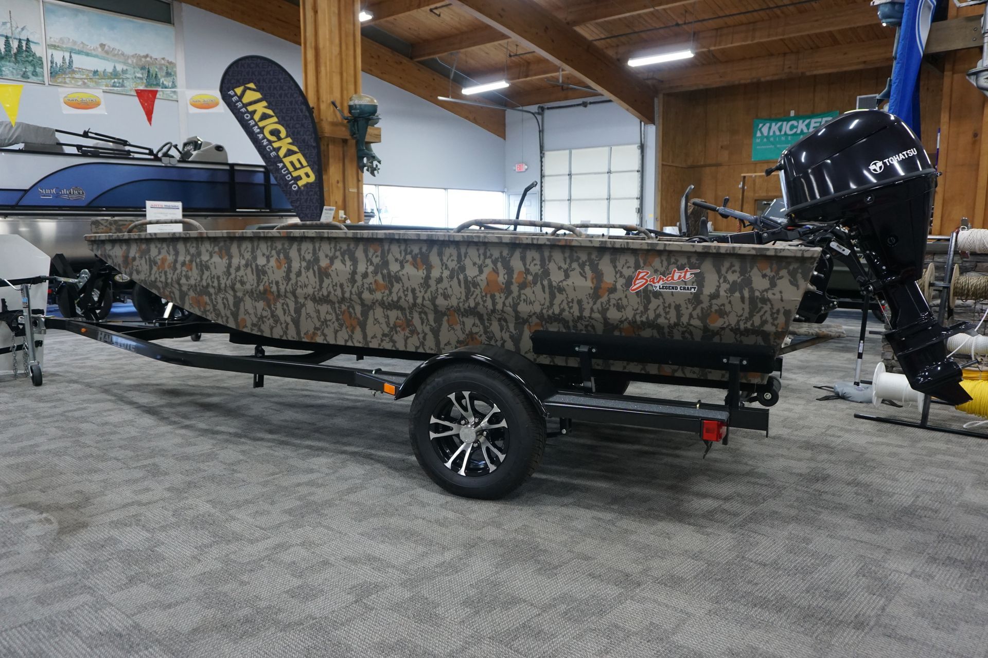 A boat is sitting on a trailer in a showroom.