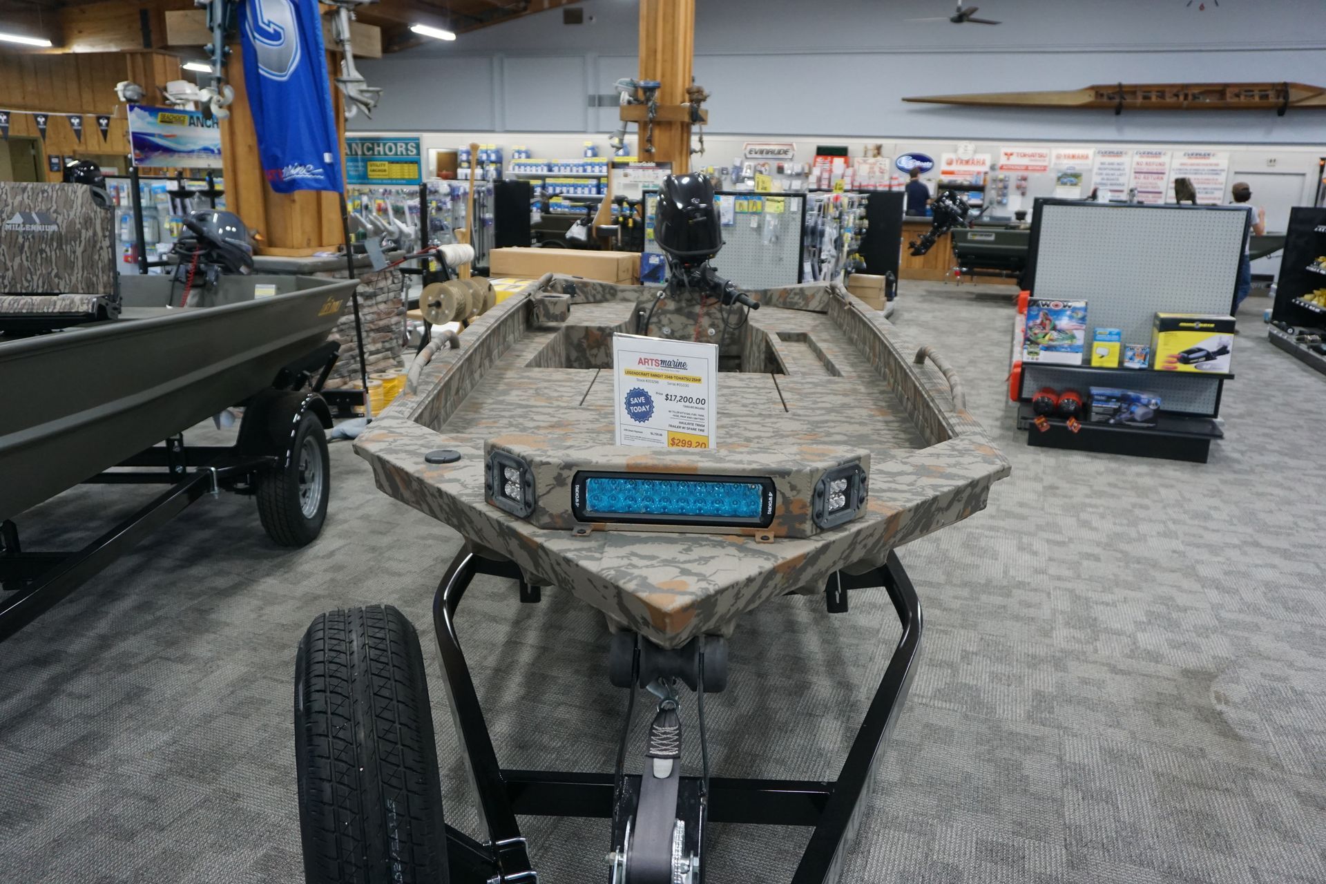 A boat is sitting on a trailer in a store.