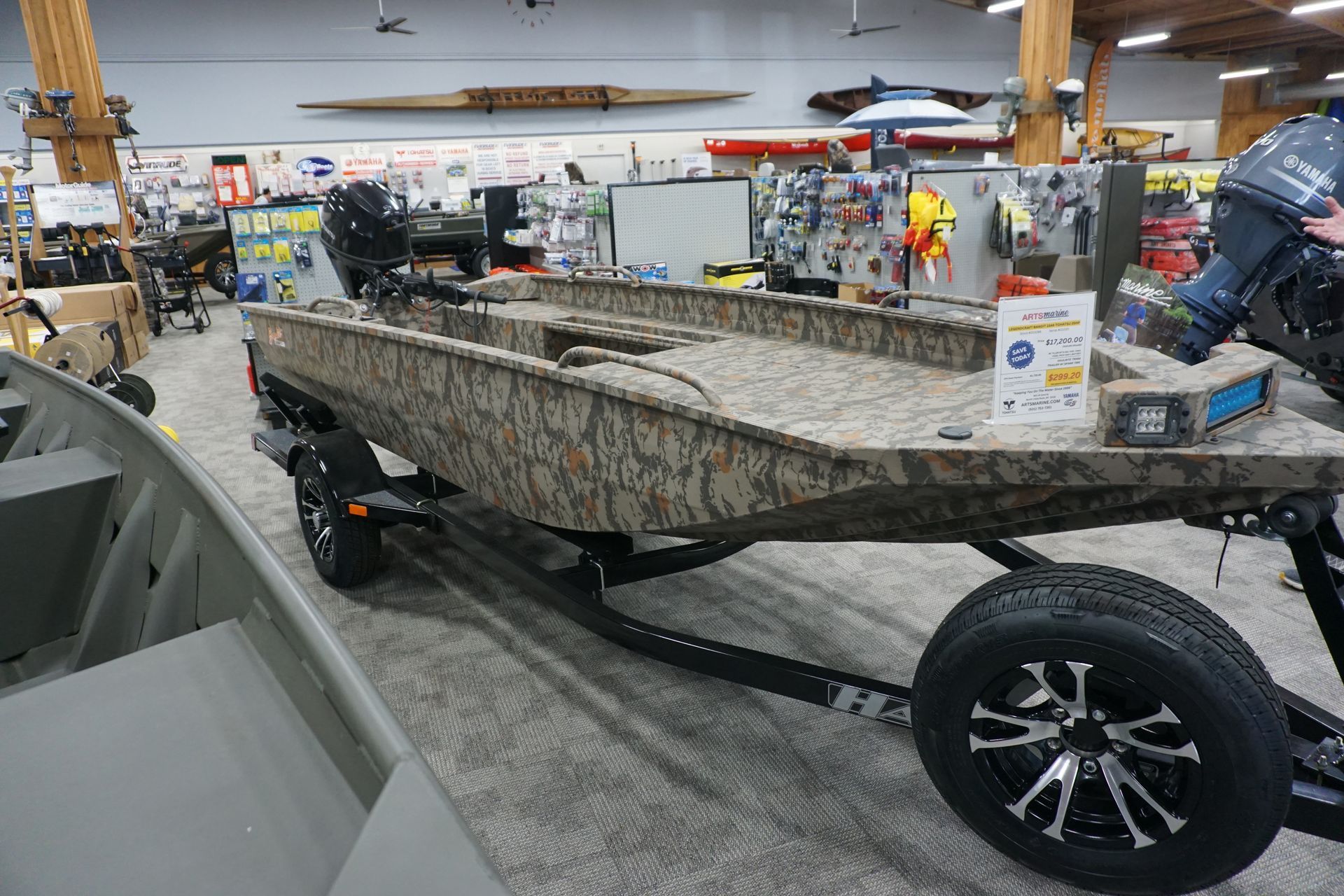 A boat is sitting on a trailer in a store.