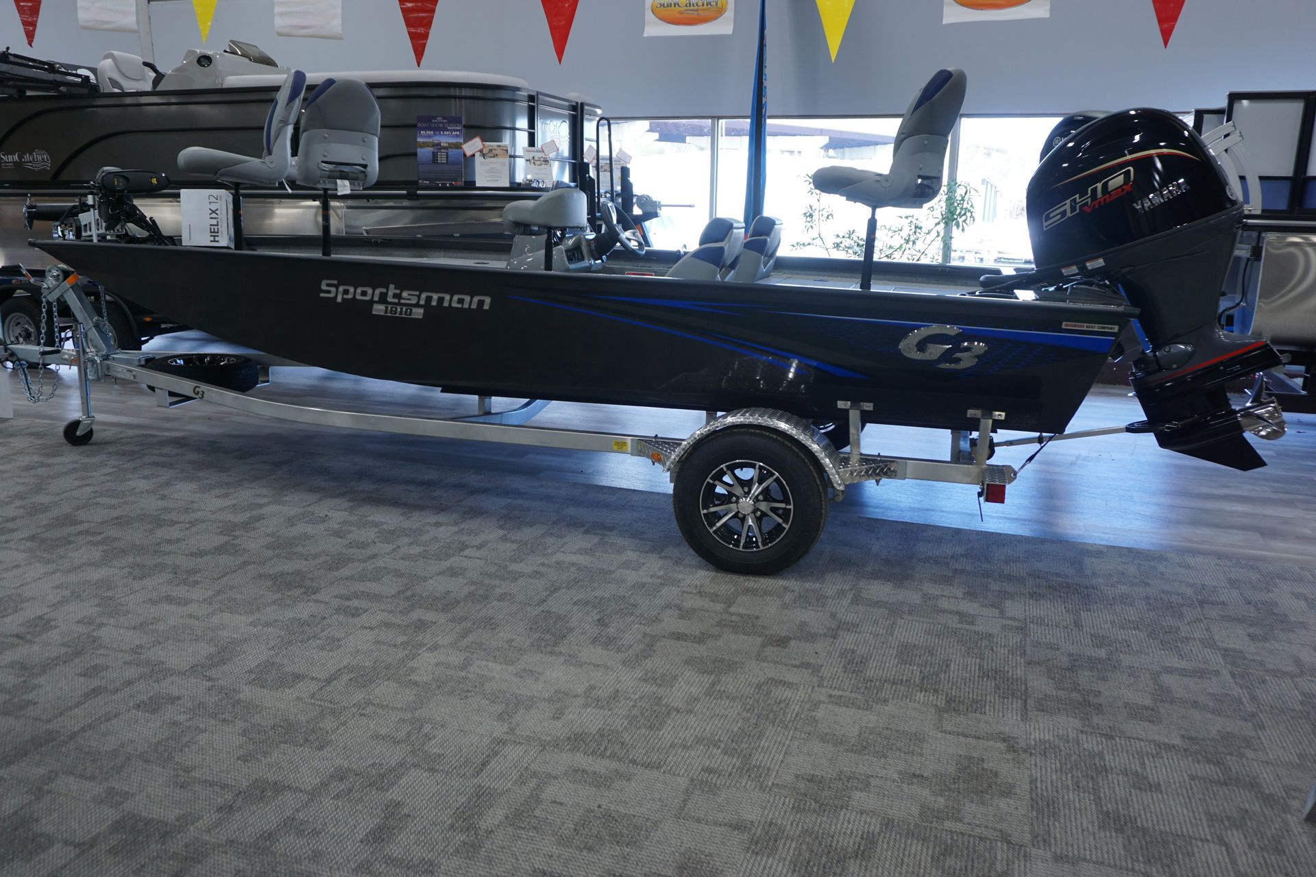 A boat is sitting on a trailer in a showroom.