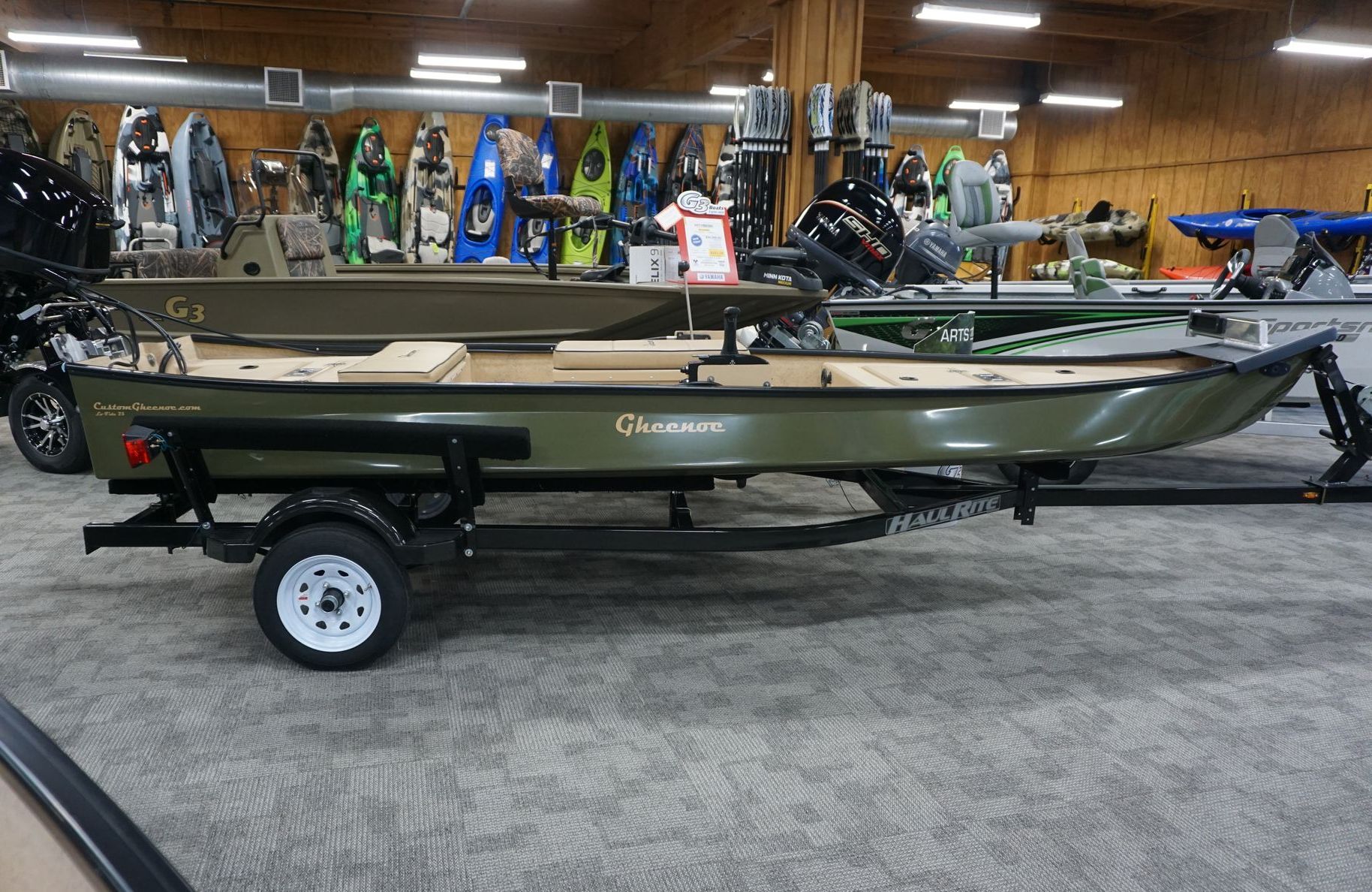 A boat is on a trailer in a parking lot.