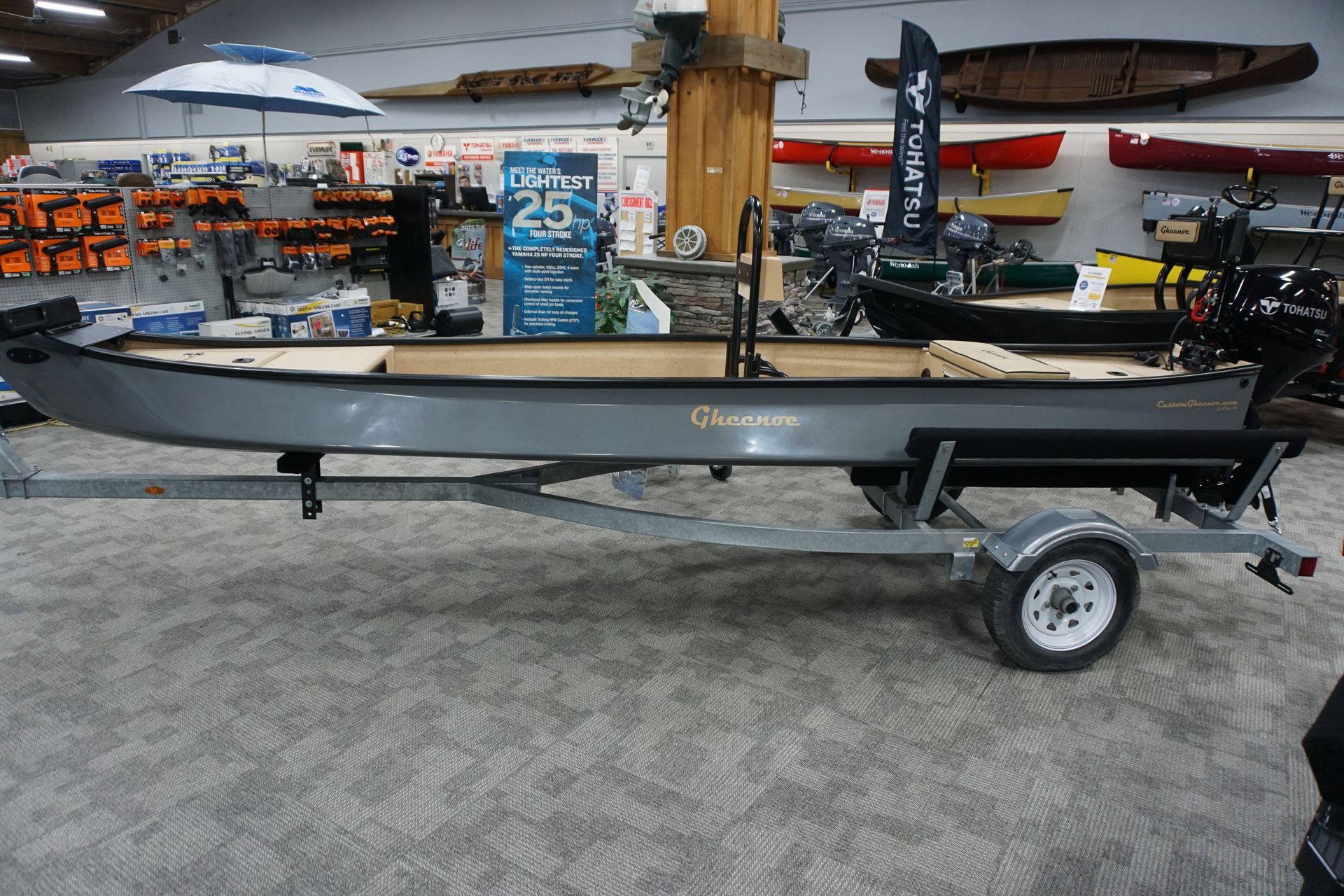 A boat is on a trailer in a store.