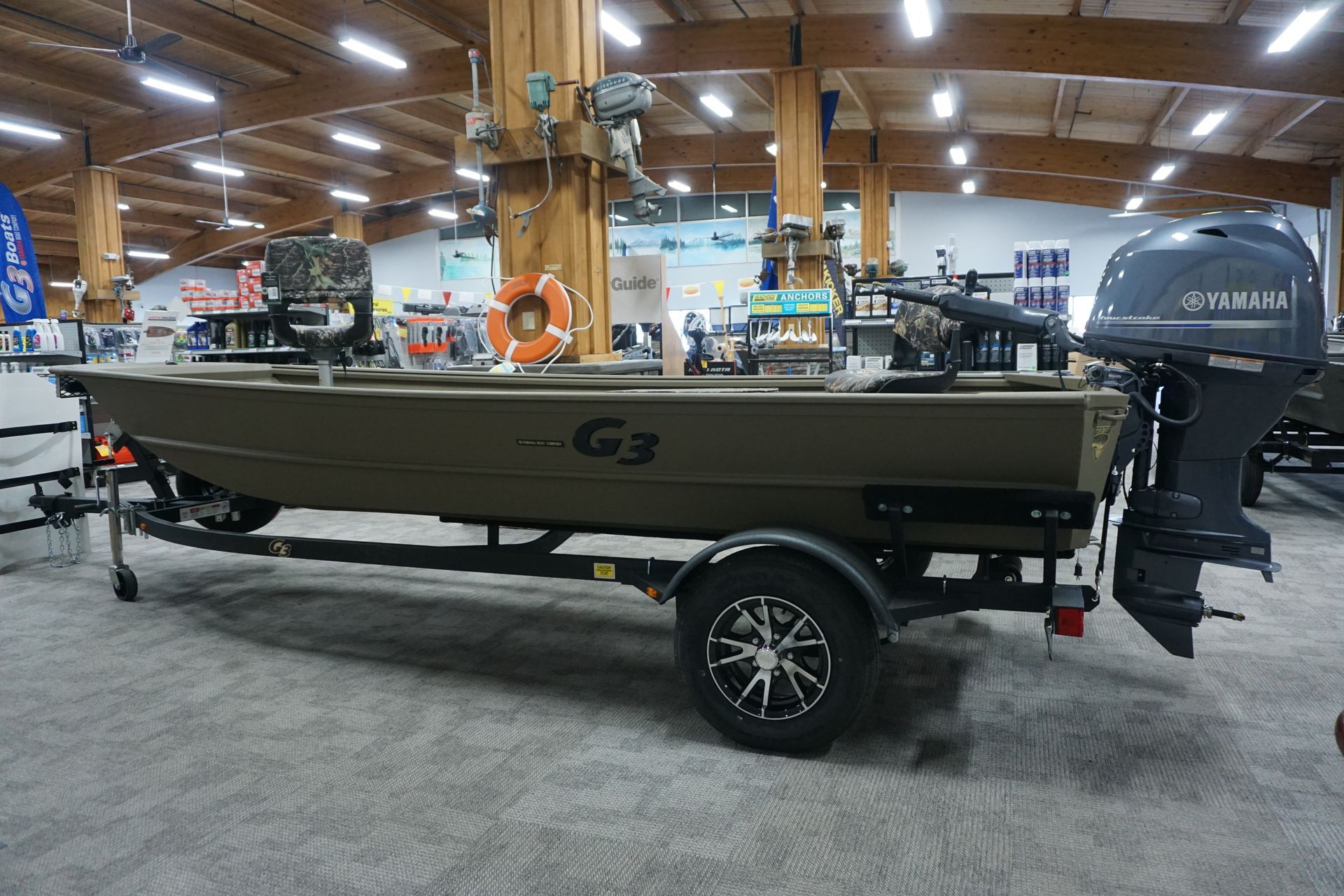 A boat is sitting on a trailer in a showroom.