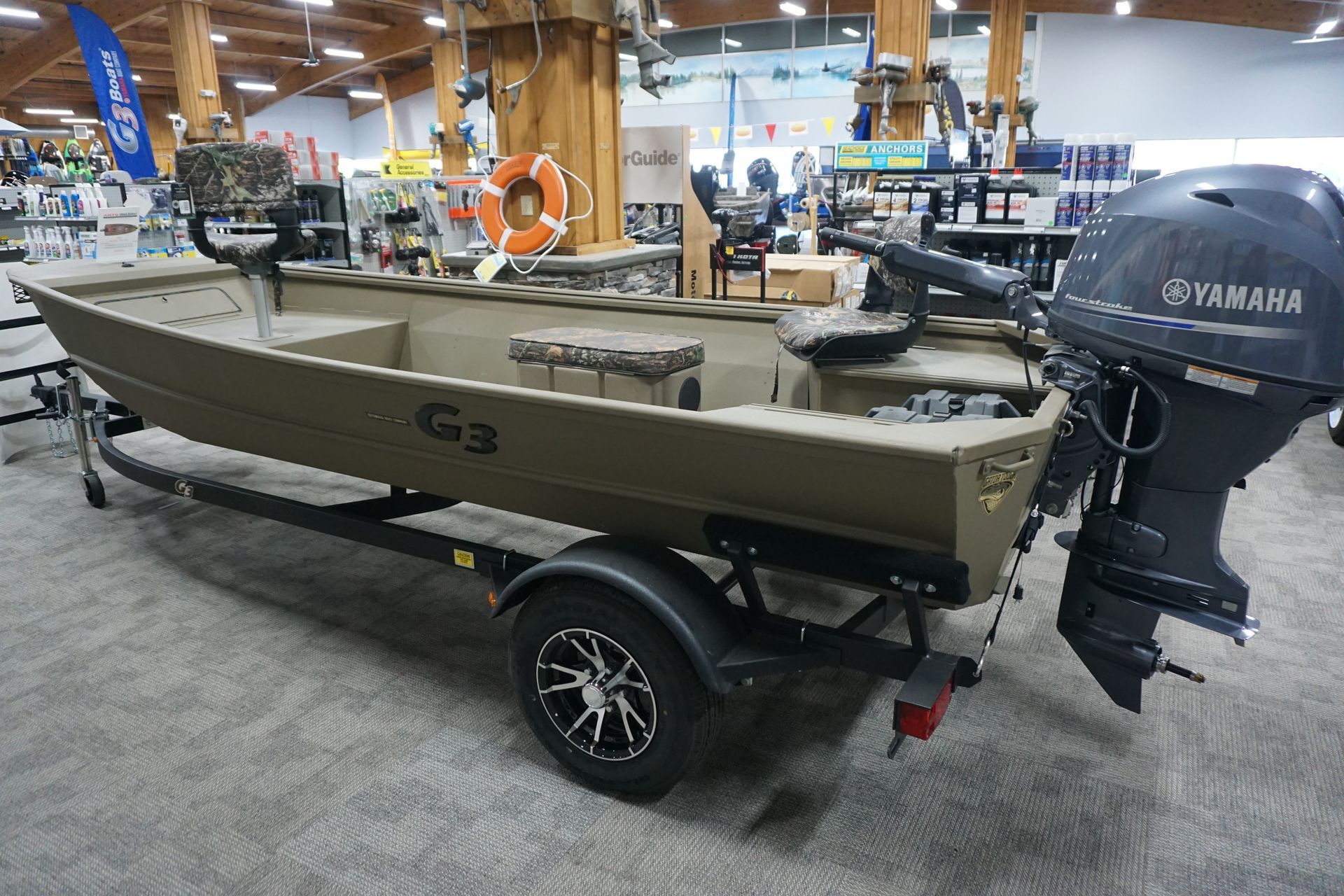 A boat is sitting on a trailer in a store.