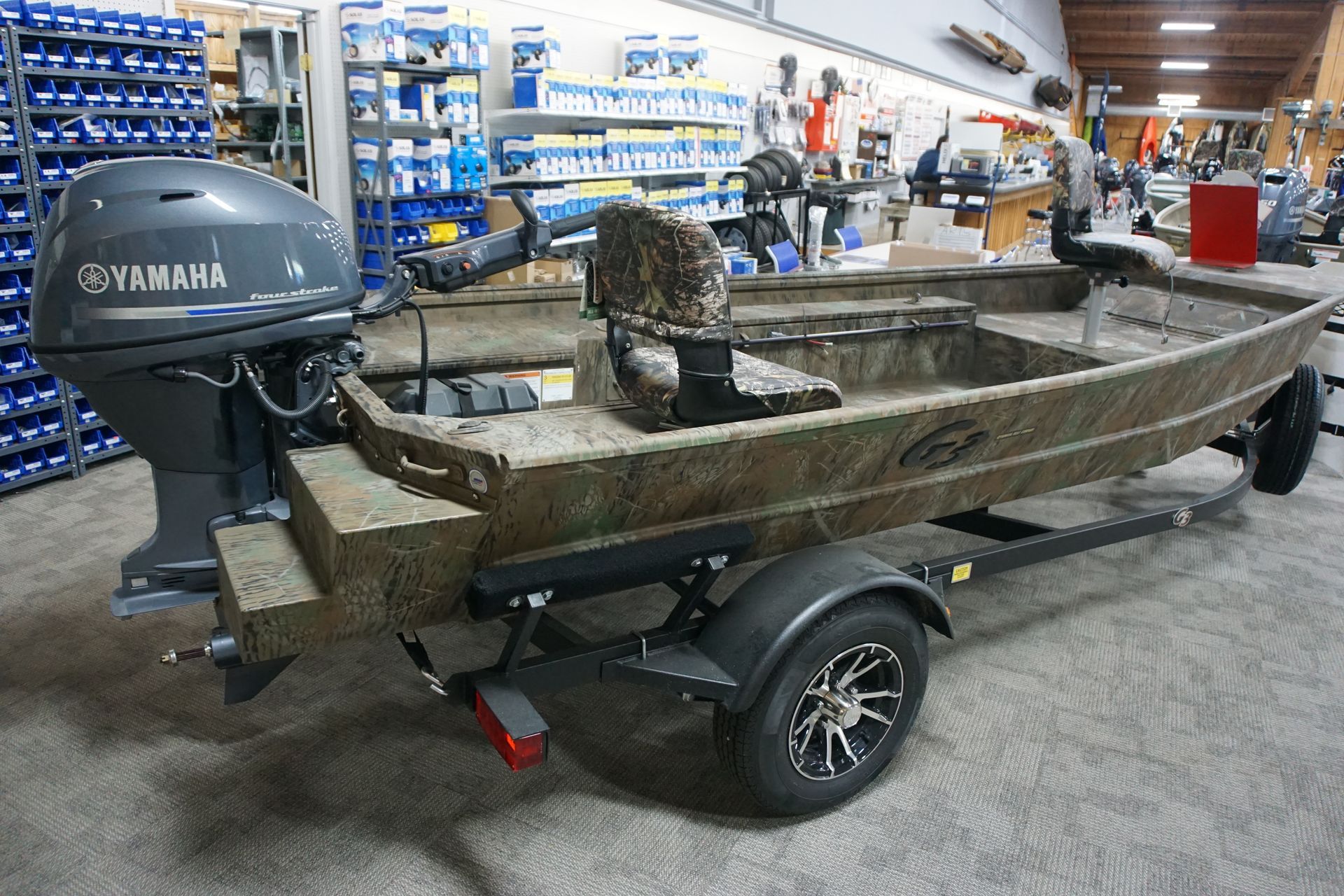 A fishing boat with a yamaha outboard motor on a trailer.