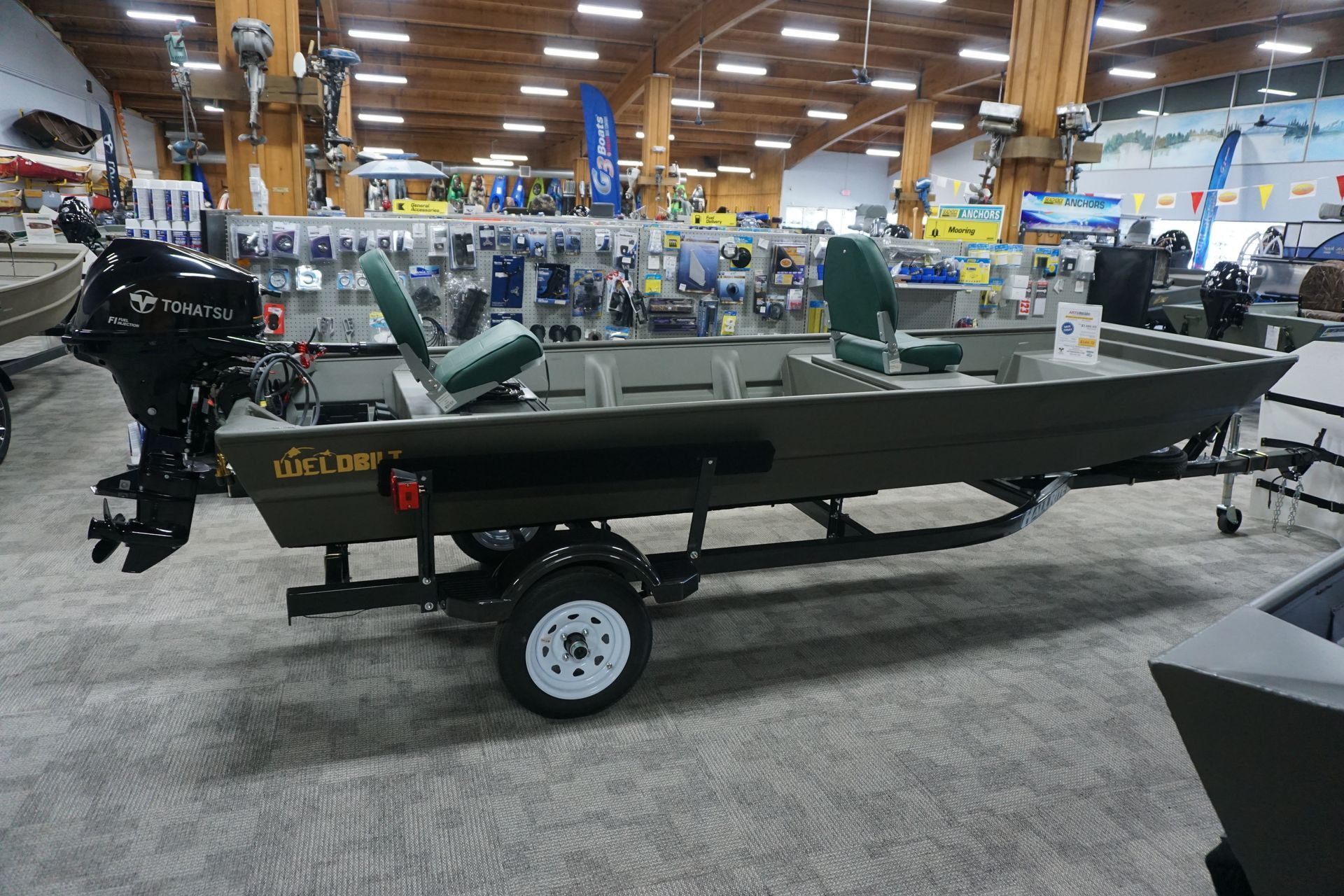 A boat is sitting on a trailer in a showroom.