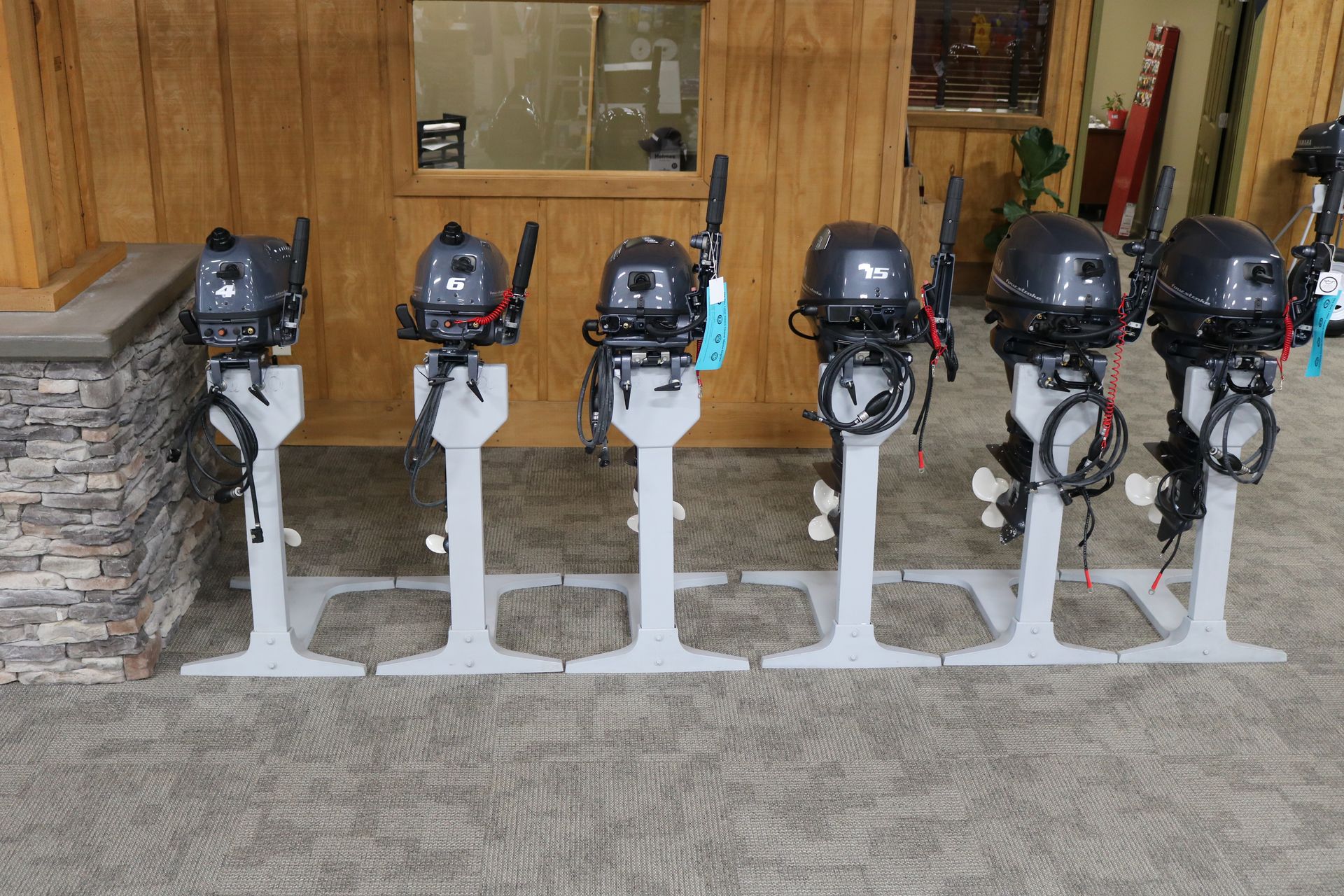 Several outboard motors are lined up in a row