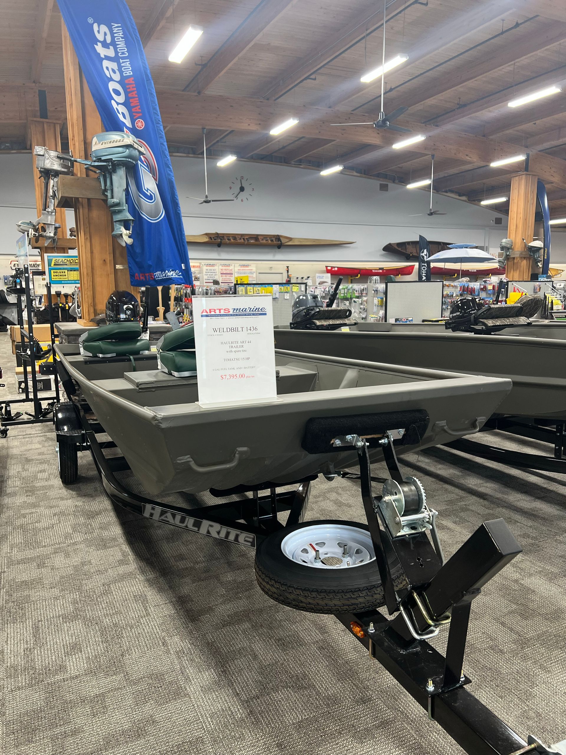 A boat is sitting on a trailer in a store.