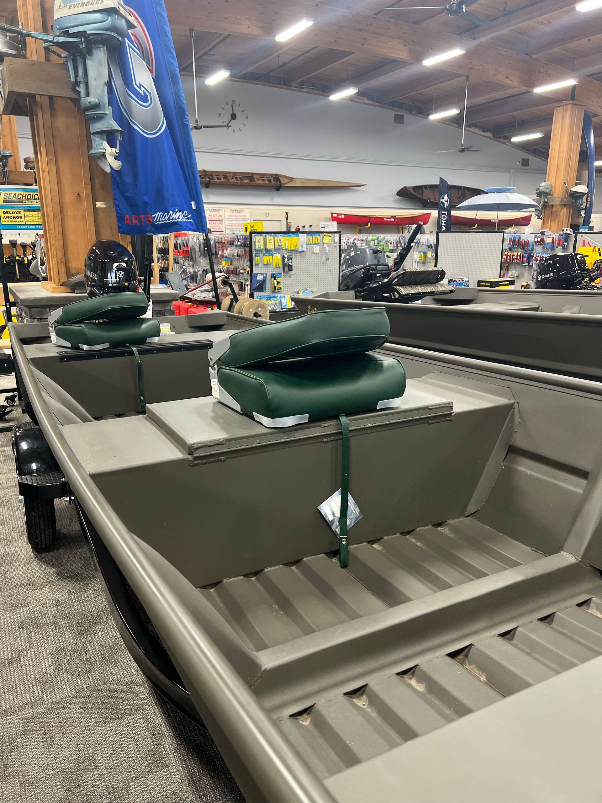 A row of boats are lined up in a store.