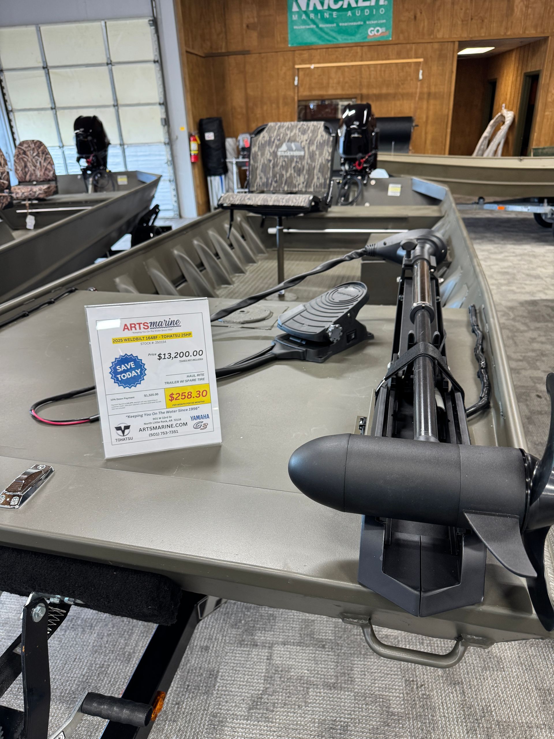 A fishing rod displayed on a store counter with product packaging nearby