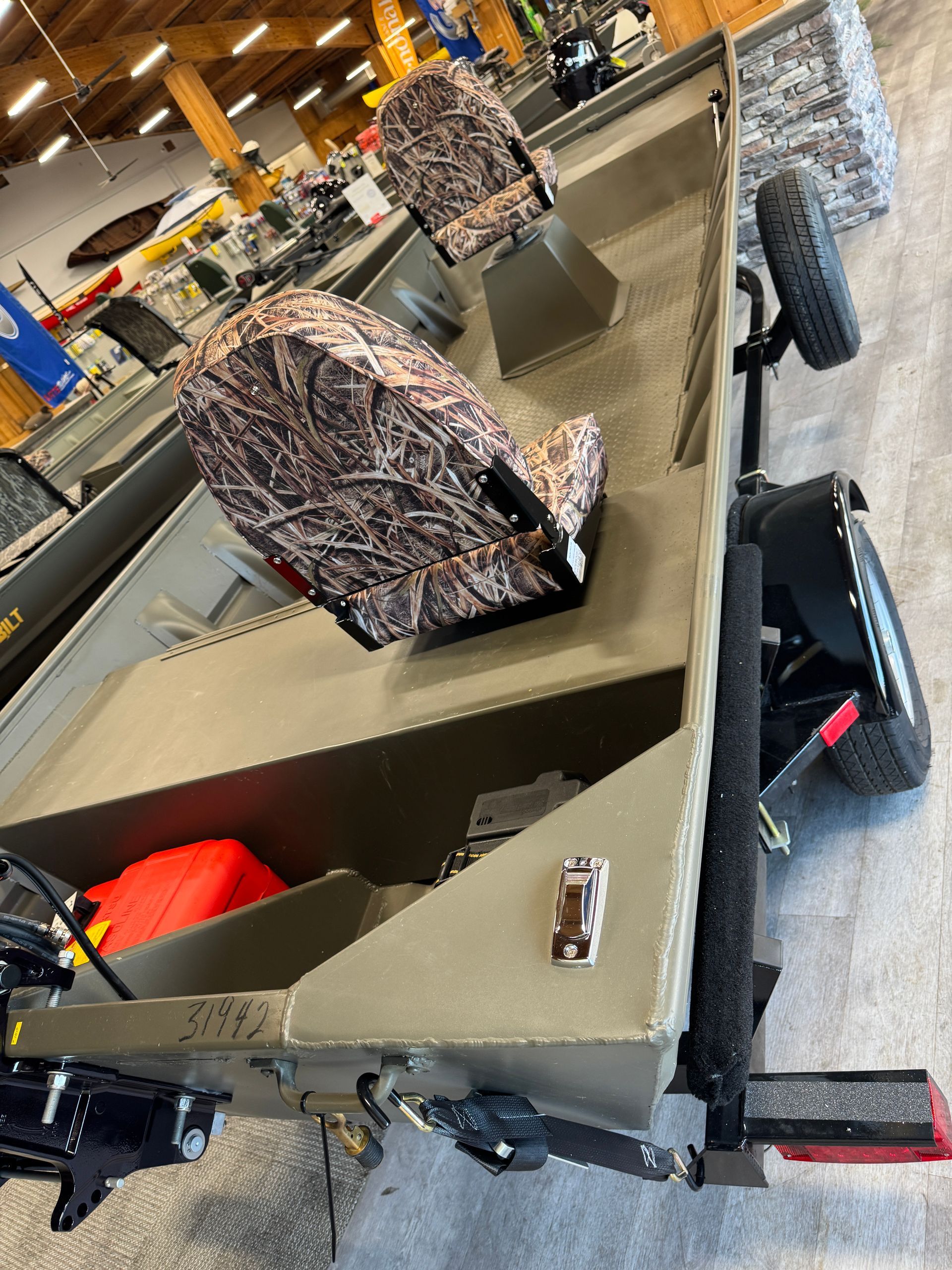 Tipped metal utility cart in a warehouse, with bundled scrap and tools inside.