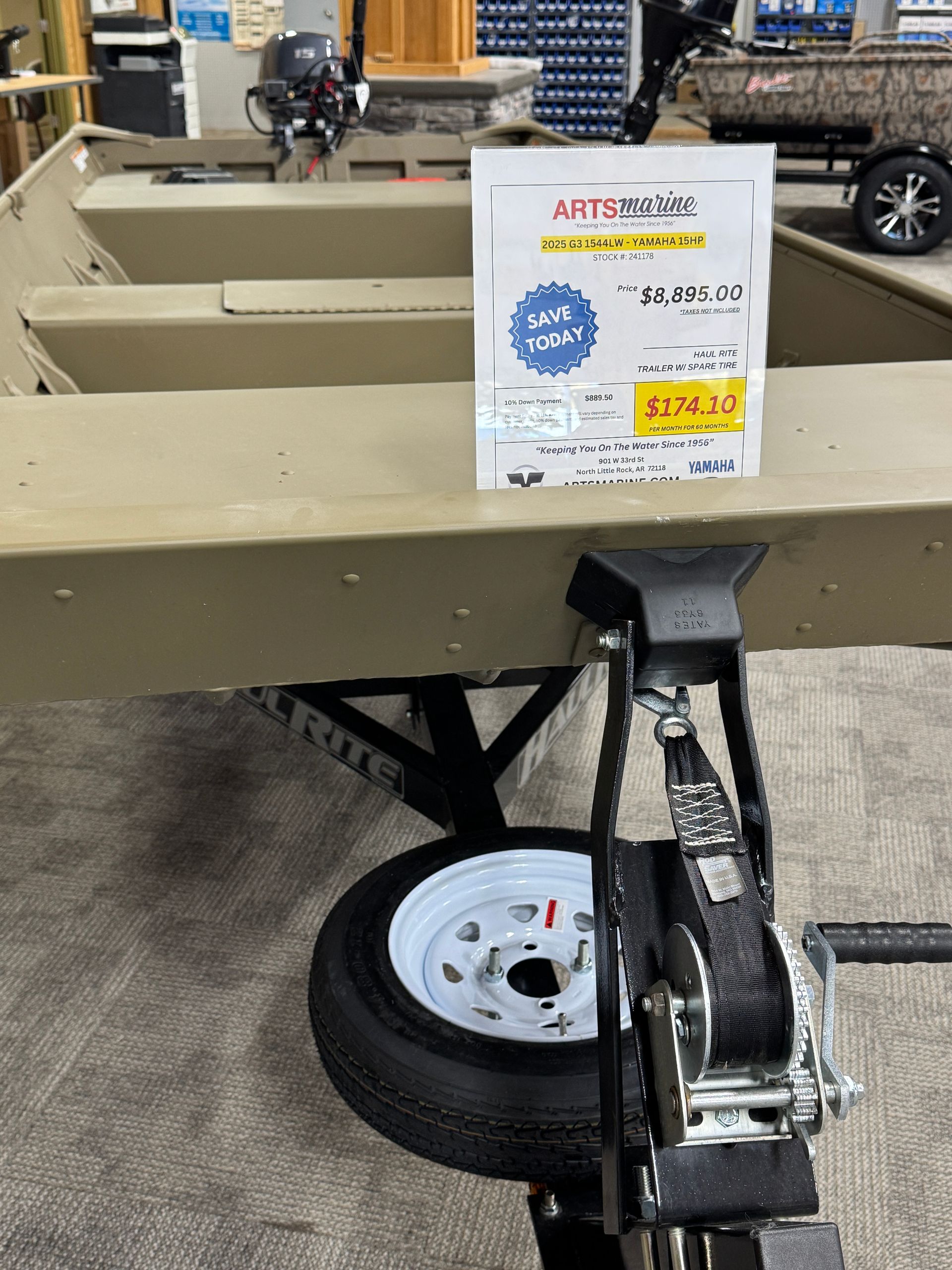 Foldable utility trailer in a store aisle with a price sign attached to the front.