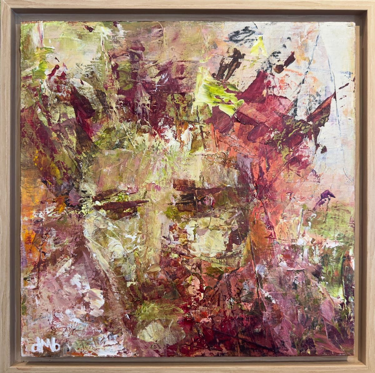 Abstract painting in a wooden frame. Earthy tones blend to suggest a face.