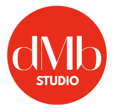 Red circle with "dMb" in white lettering above "STUDIO".