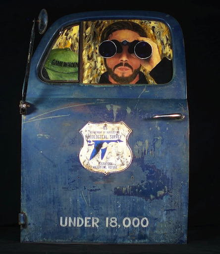 Blue vintage car door with a man looking through binoculars; 