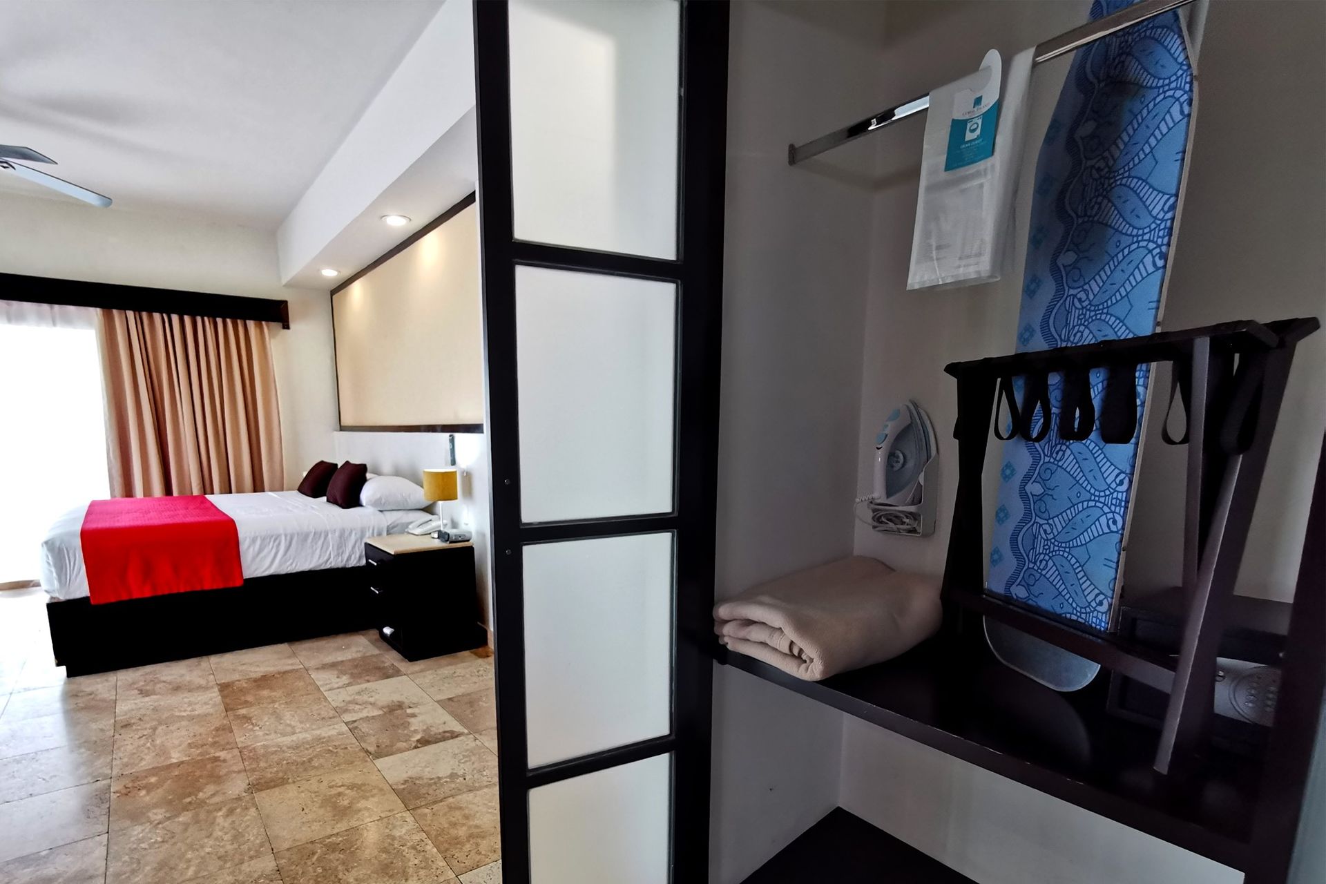 A hotel room with a bed and a closet