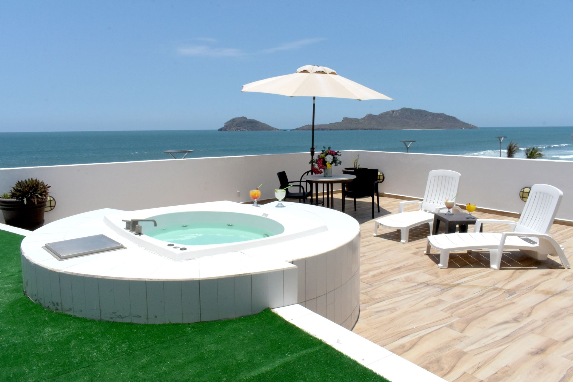A jacuzzi on a rooftop overlooking the ocean