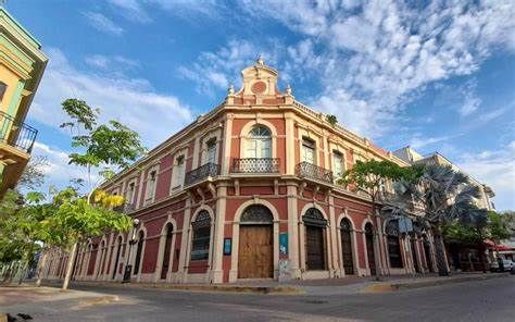 A large building is on the corner of a street.