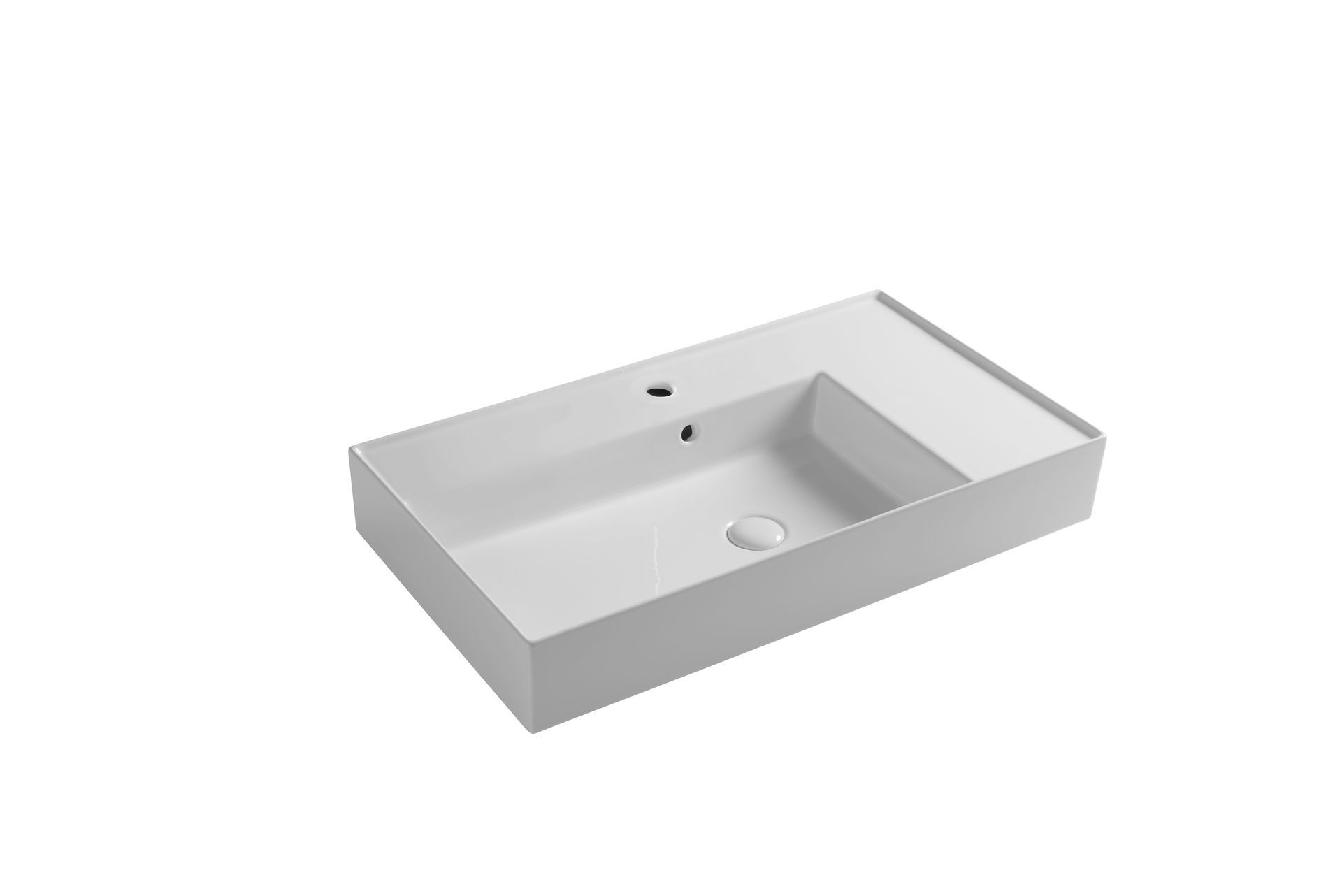 Lavandino rettangolare bianco per il bagno con un piccolo ripiano laterale integrato.
