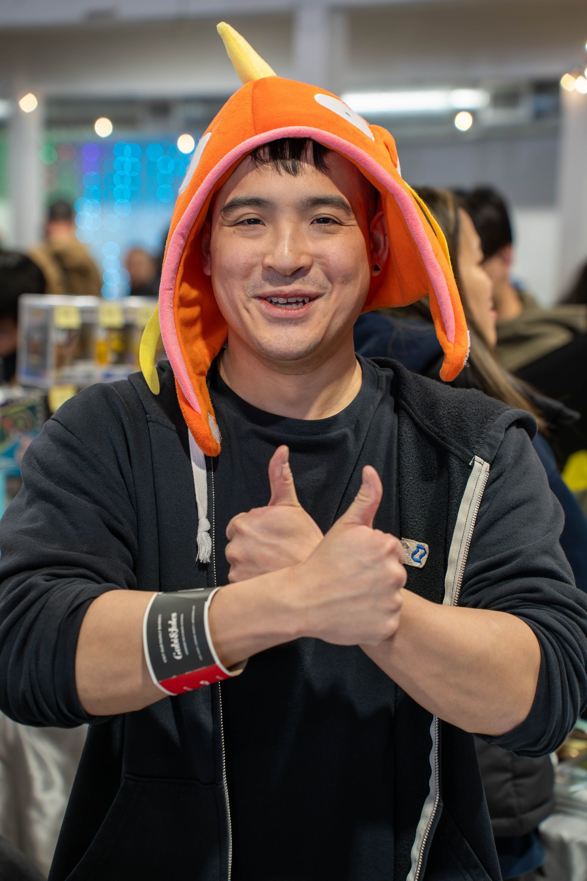 vendor at nextgen card show with magikarp hat on