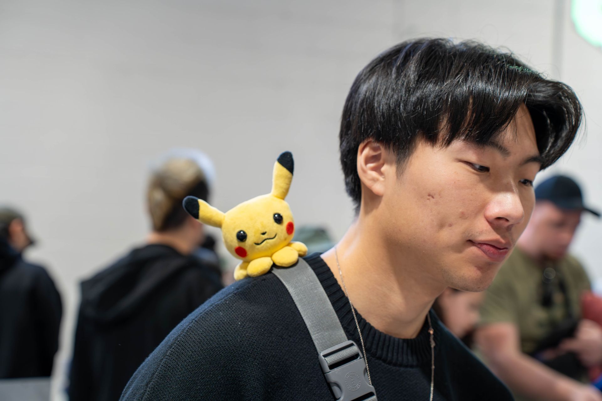 vendor with a pikachu on his shoulder