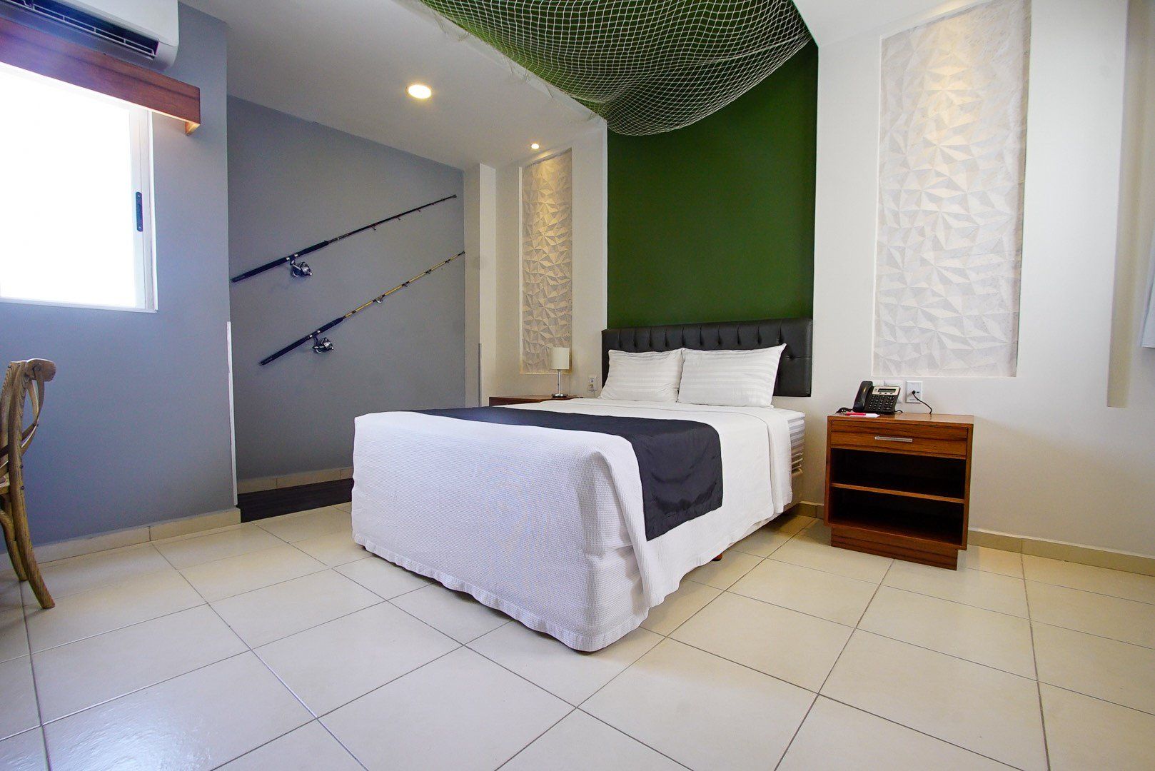 A hotel room with a bed and a nightstand