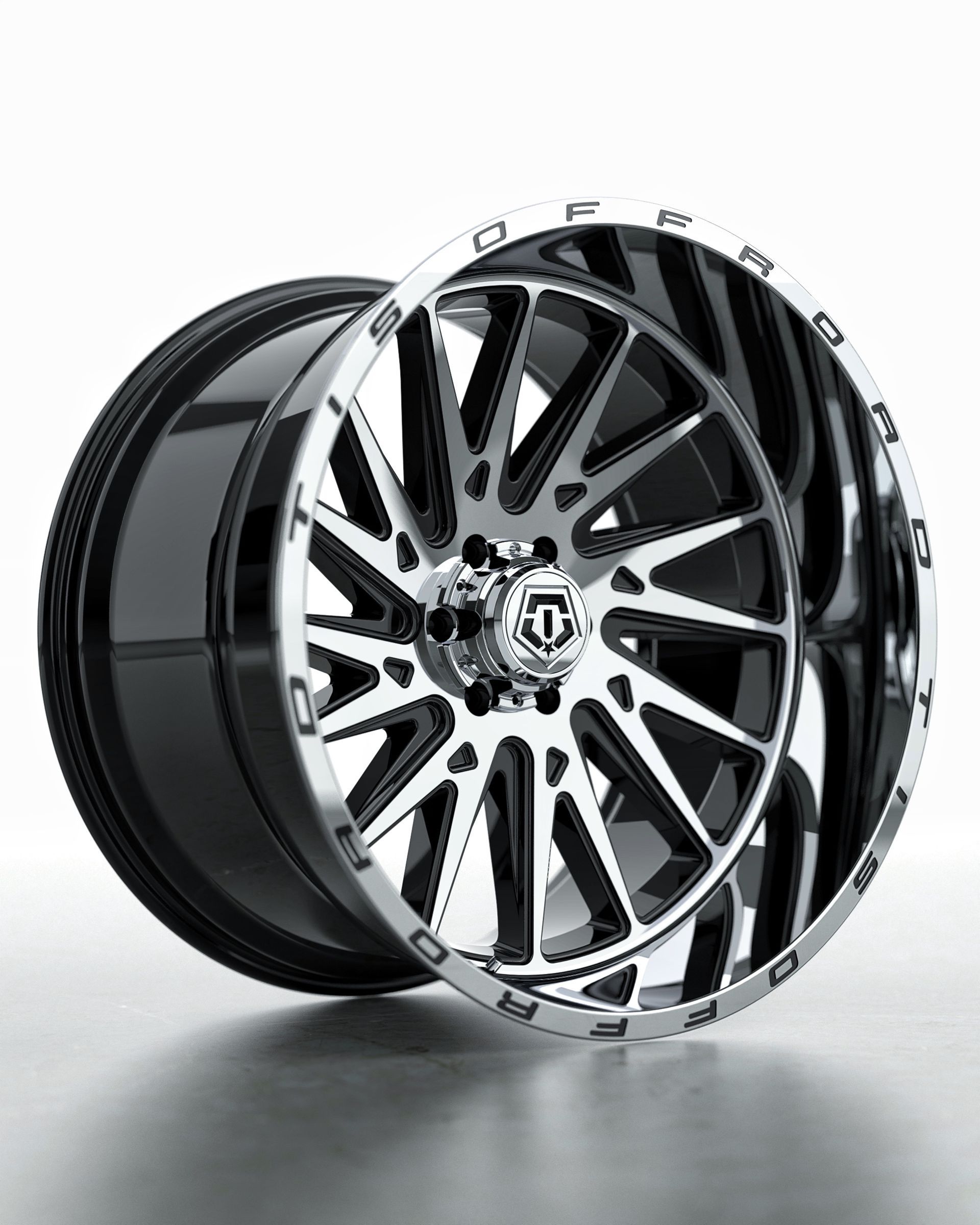 A close up of a chrome wheel on a white background