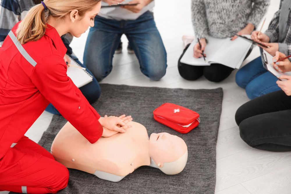 Practicing Fire Safety Procedures, a Woman in a Red Uniform Demonstrates on a Mannequin - Central West NSW
