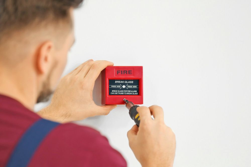Skilled Technician Securing Fire Alarm with Screwdriver - Muswellbrook NSW