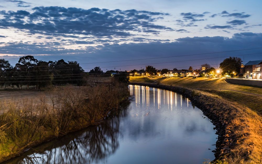 Evening View of Canal with Illuminated Houses - Maitland NSW