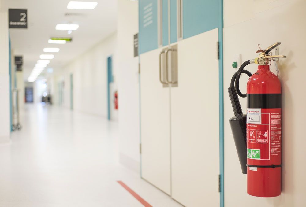 Display of Fire Hose Adjacent to Fire Extinguisher in Hallway - Upper Hunter Valley NSW