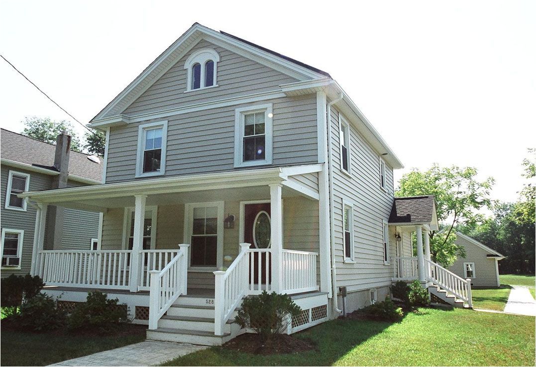 A white house with a porch and stairs